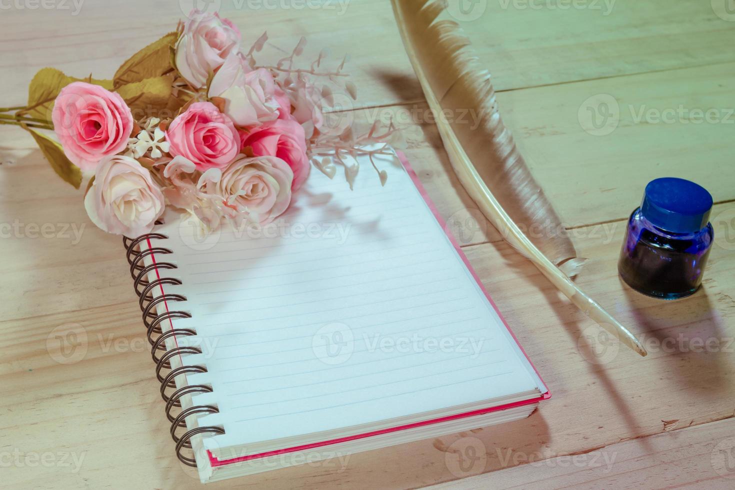 open note book with feather pen,filter effect. photo