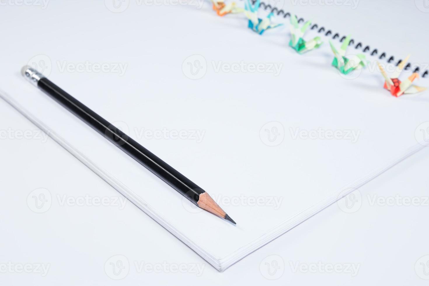 closeup open note book with pencil on background photo