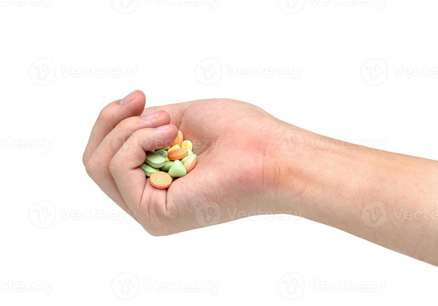 Hand holding pill isolated on white background photo