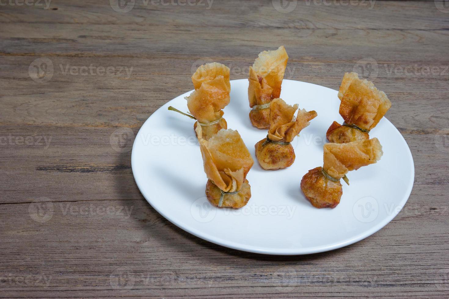fried wonton or Toong Tong on wood background photo