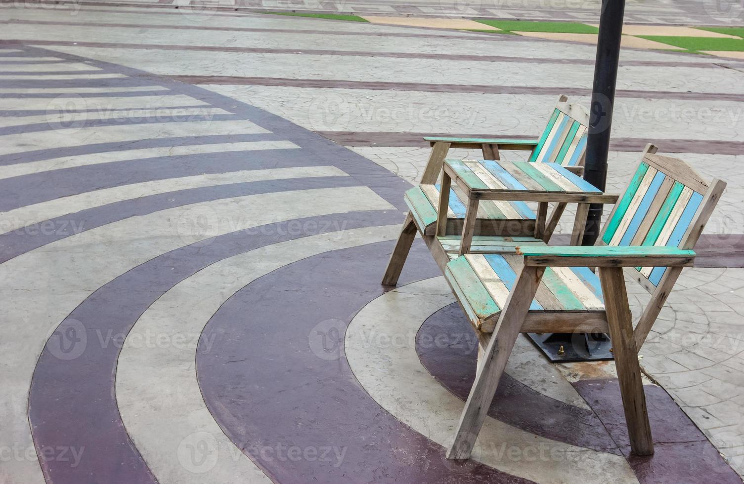 Old wooden chairs outdoors with bricks floor photo