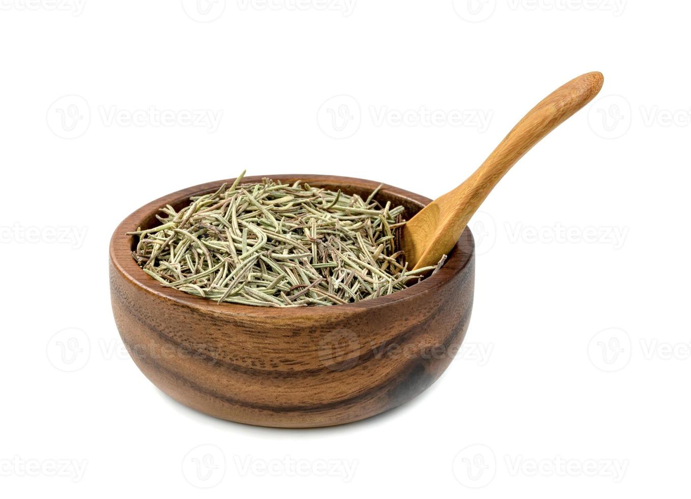 Dry rosemary in wooden bowl and spoon isolated on white background photo