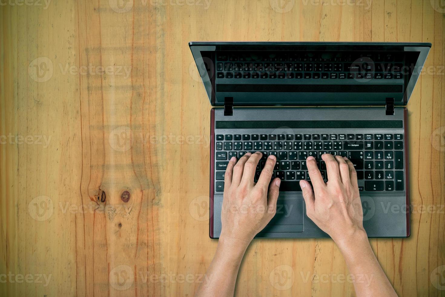 man using laptop on desk photo