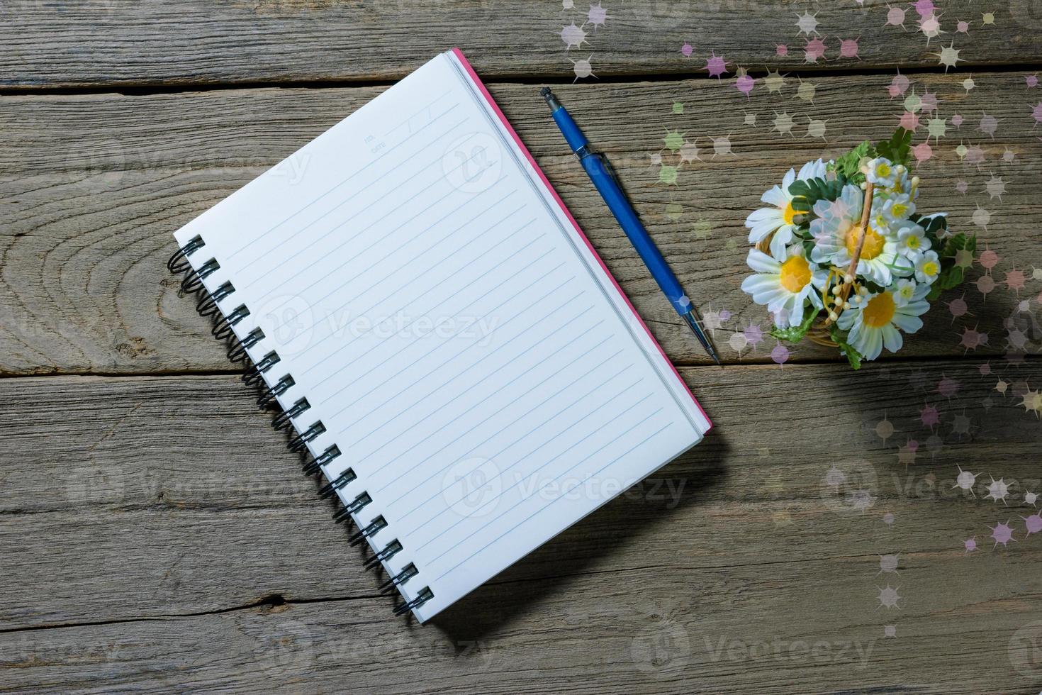 open note book with clutch-type pencil on wood background photo
