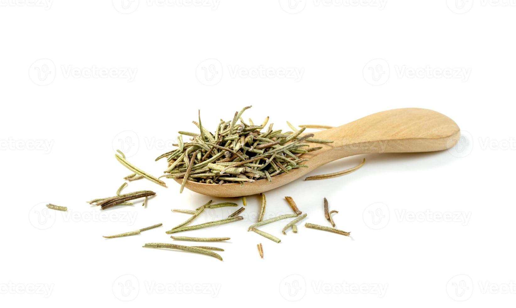 Dry rosemary in wooden spoon isolated on white background photo