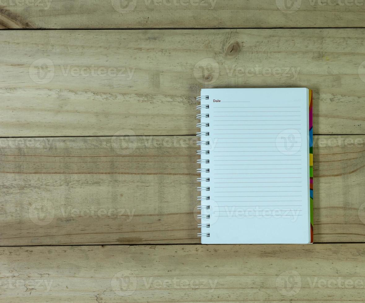 open note book on wooden background photo