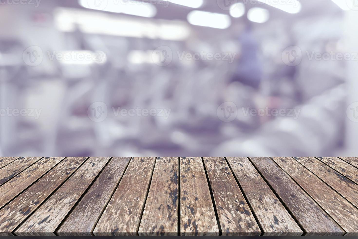 Empty wooden board space platform with blur fitness gym equipment background photo