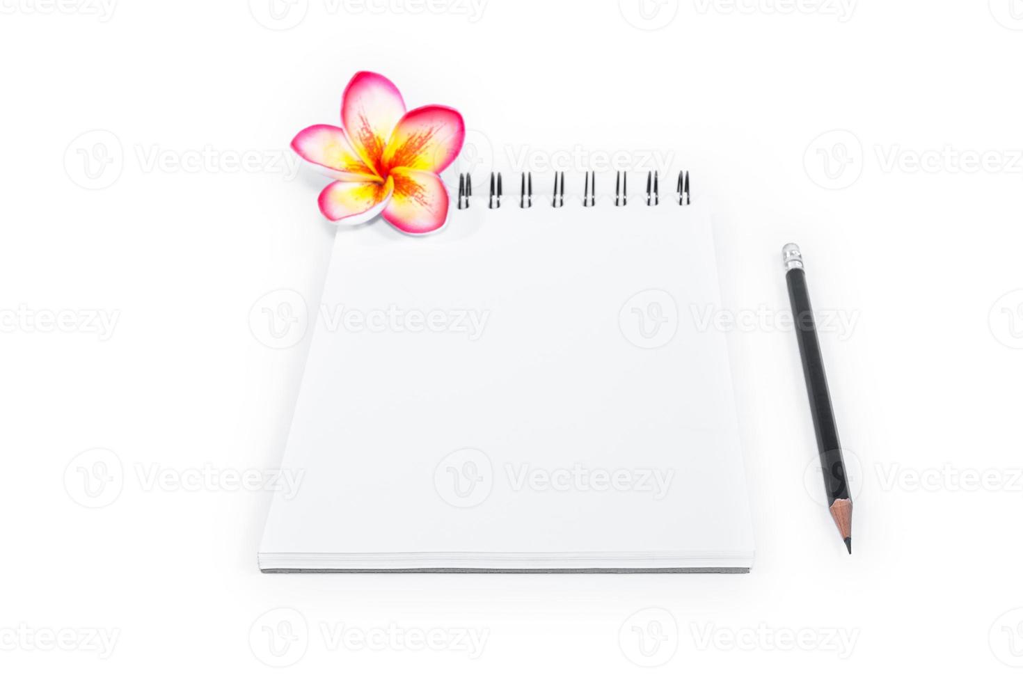 closeup open note book with pencil on background photo