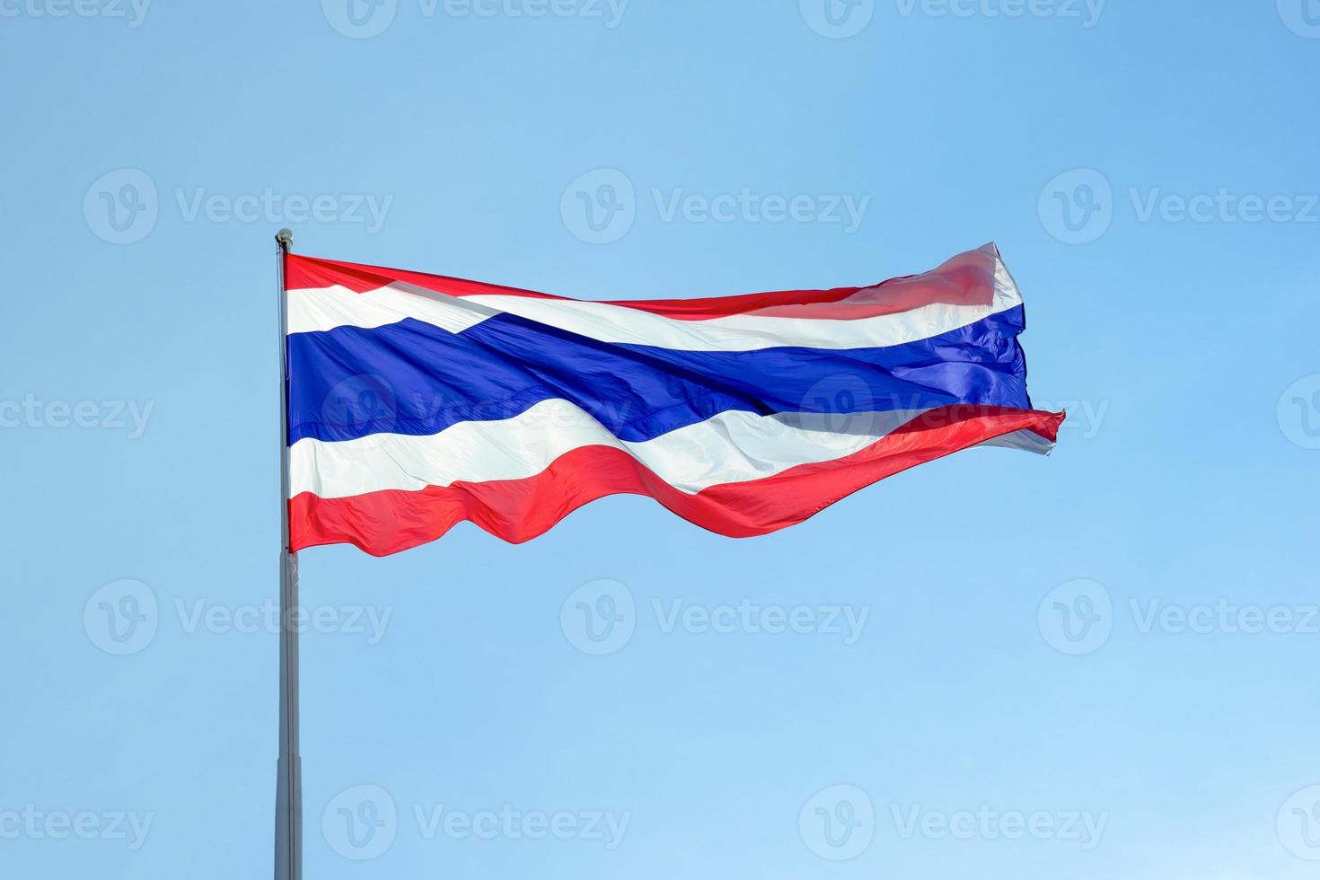 Flag of Thailand under blue sky photo