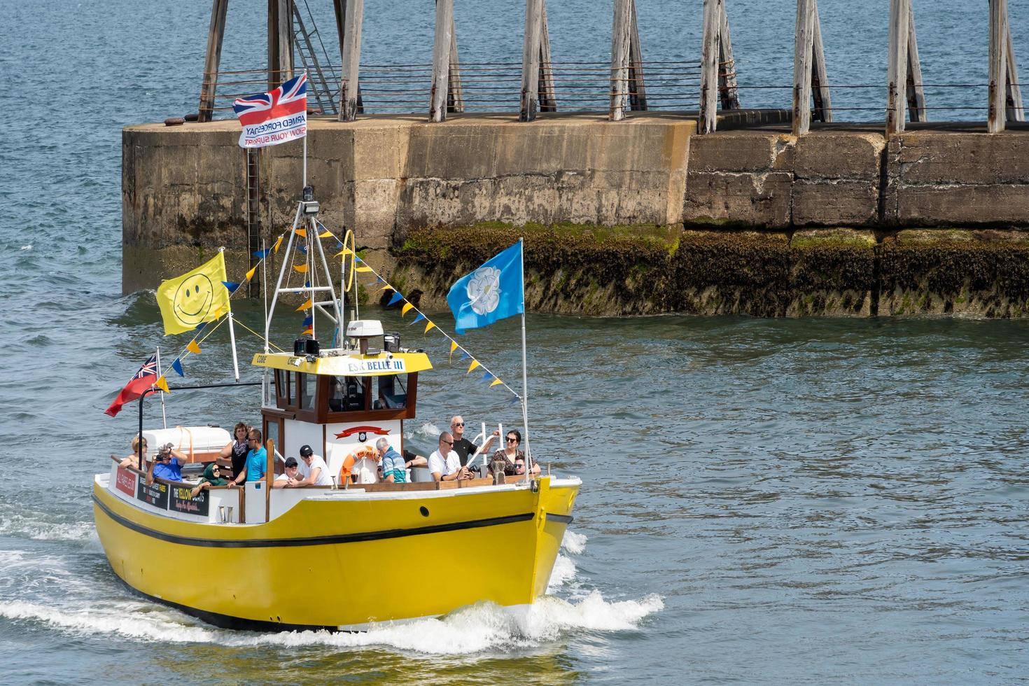 WHITBY,  NORTH YORKSHIRE, UK - JULY 19. Pleasure boat heading tinto Whitby, North Yorkshire on July 19, 2022. Unidentified people photo