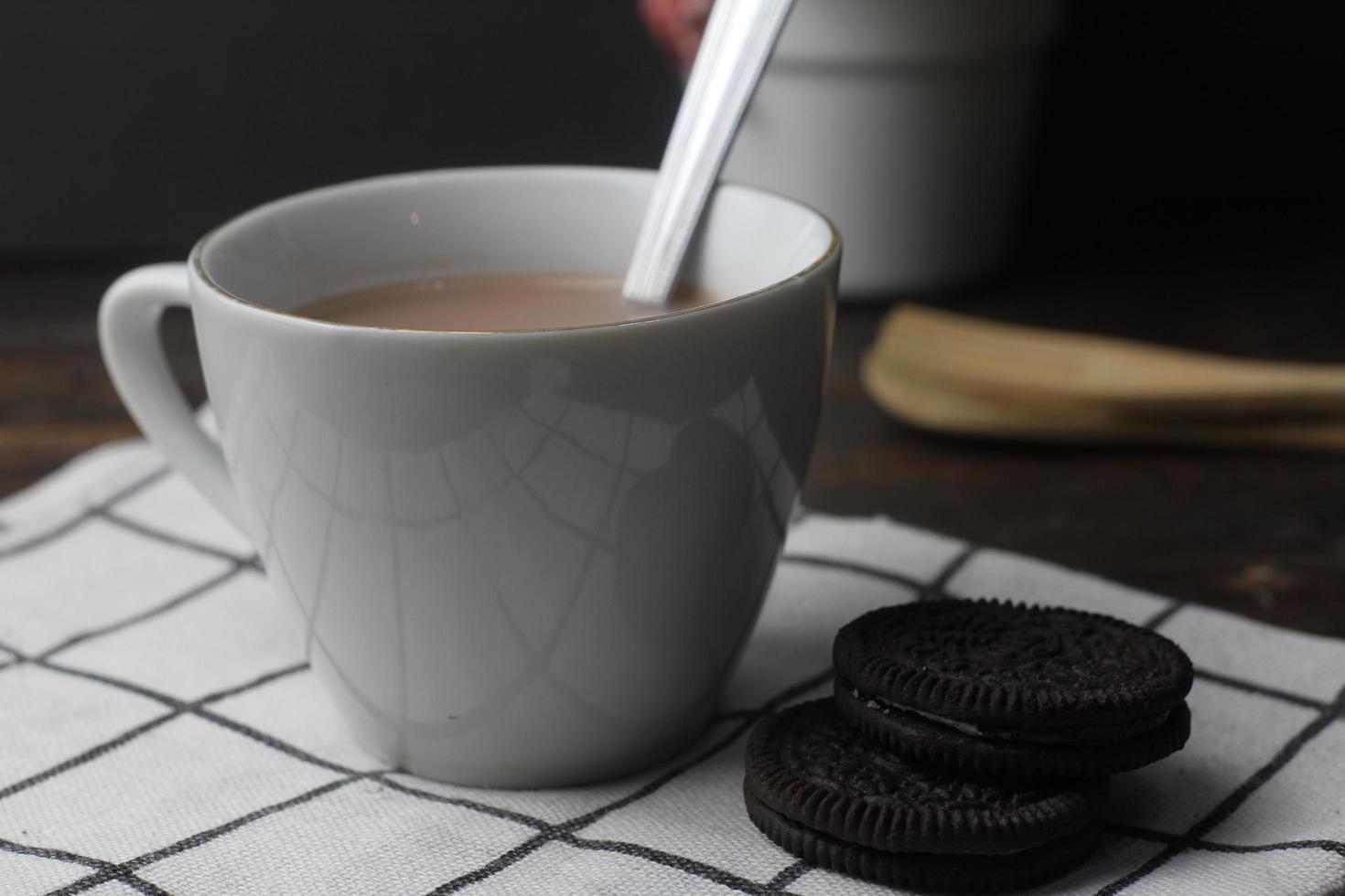 Dark chocolate cookies and a cup of chocolate milk photo