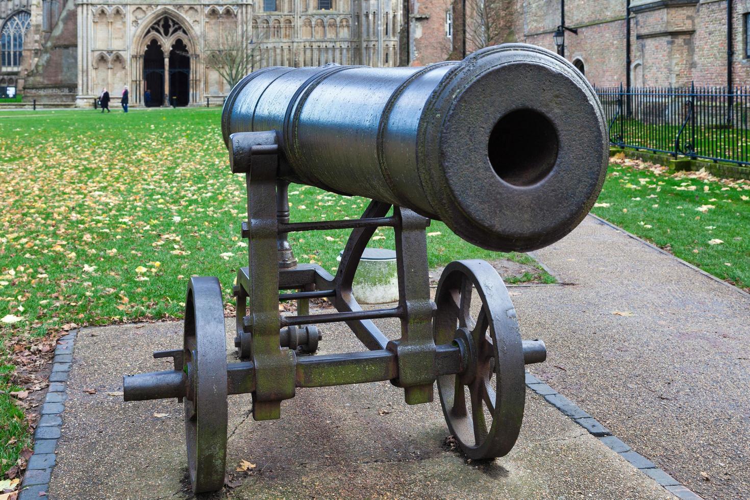 ELY, CAMBRIDGESHIRE, UK - NOVEMBER 22. Cannon outside Ely Cathedral in Ely on November 22, 2012. Three unidentified people photo