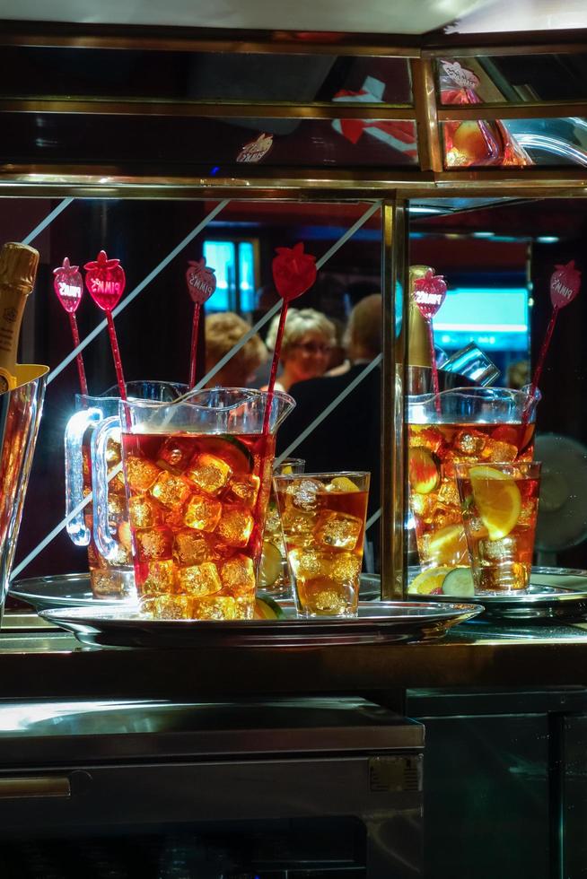 LONDON - JULY 27. Jugs of a fruity alcoholic drink awaiting collection in a theatre in London on July 27, 2013. Three unidentified people. photo