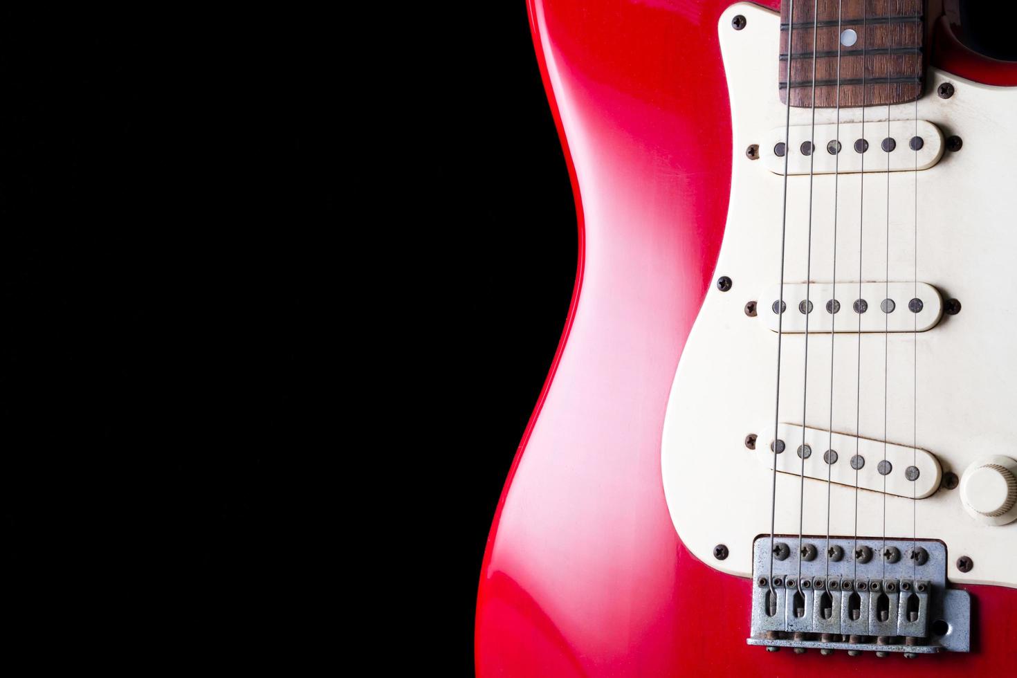 Close up of Electric guitar on black background. photo