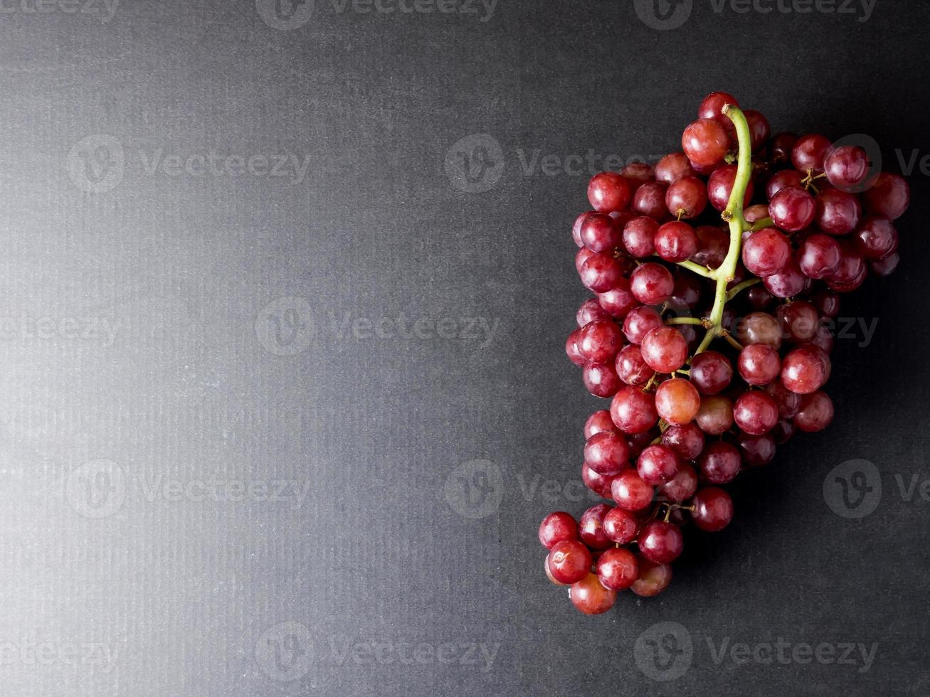 Top view of Red grapes on a black background. Free space for text photo