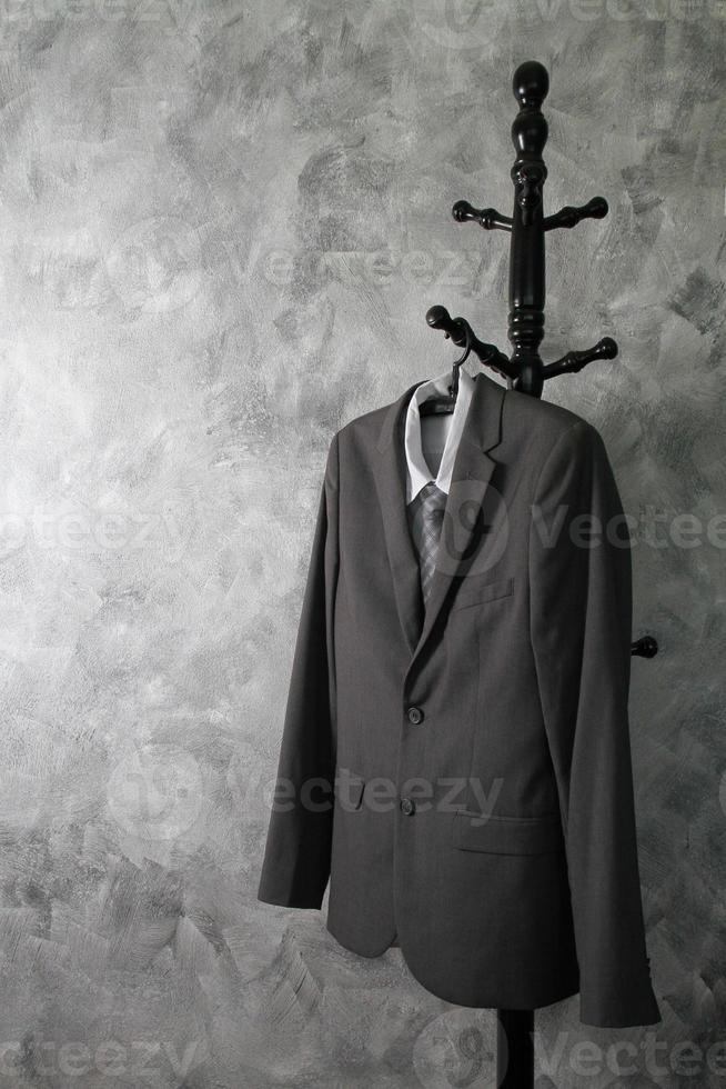 Gray suit and tie and white shirt on grunge background. photo