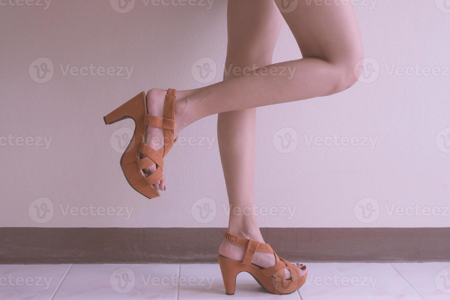 Close up of female lags with high heels shoes. photo