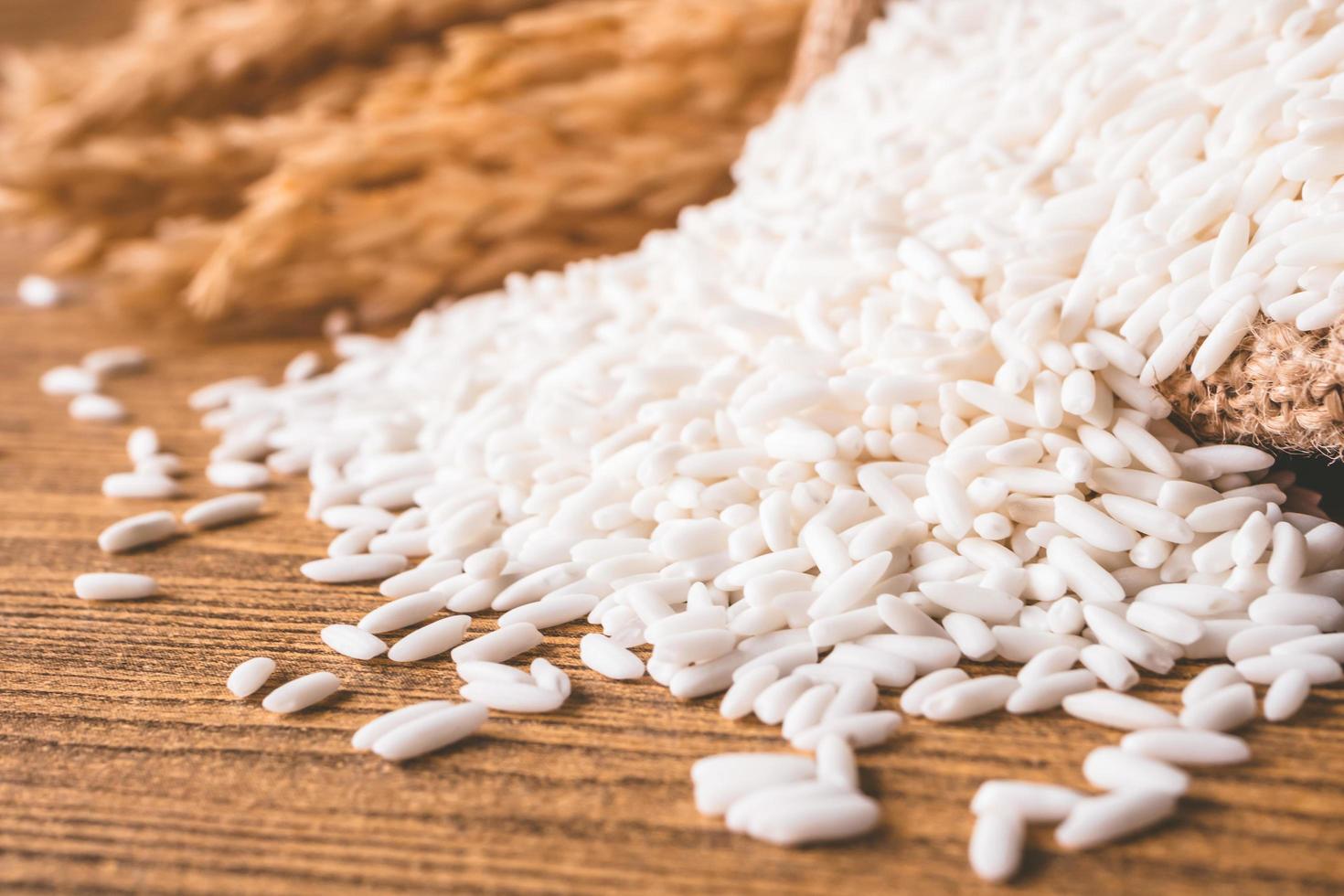 Close up of raw rice on wooden table. photo