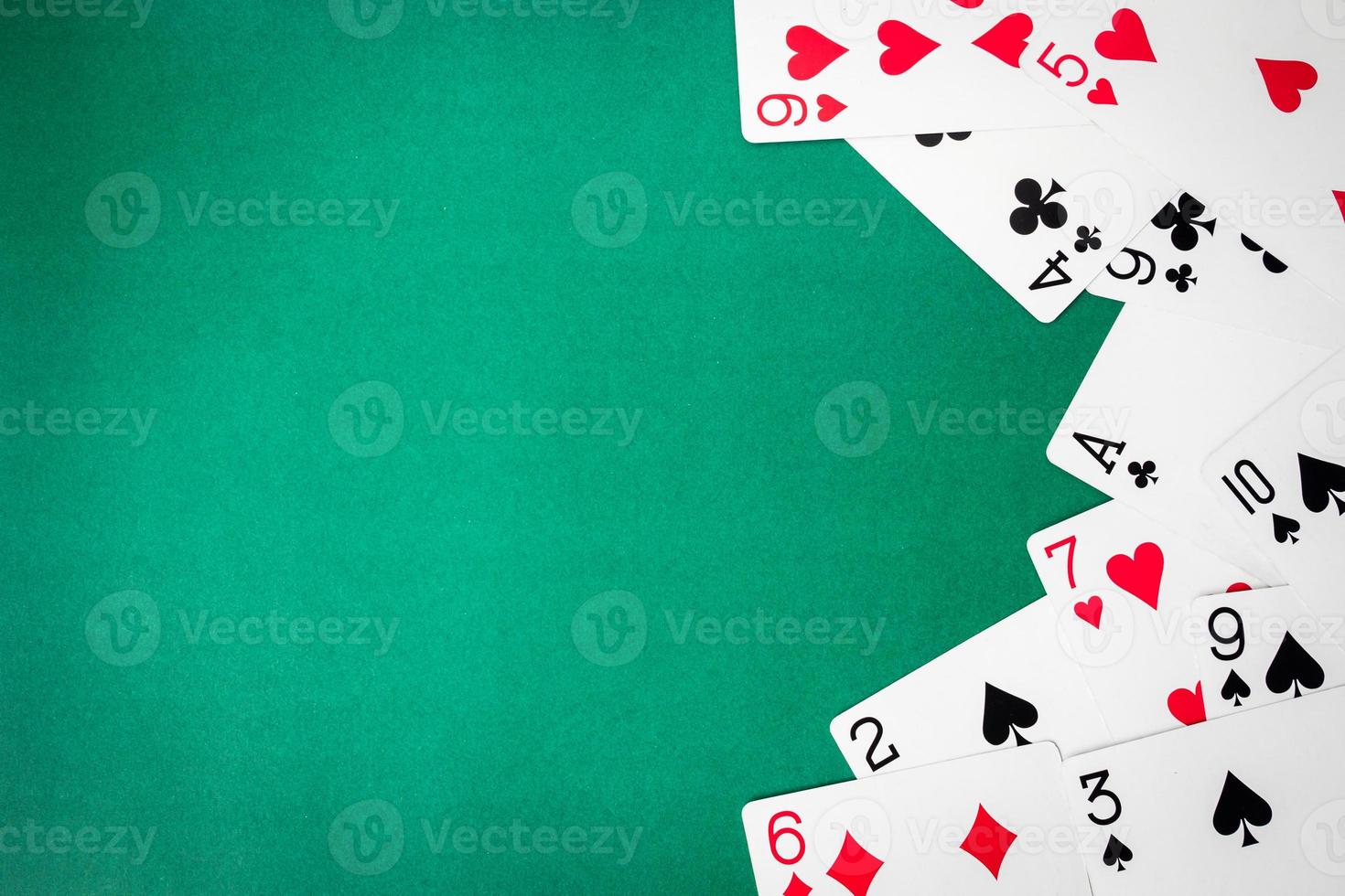 Playing cards on green background. Free space for text photo