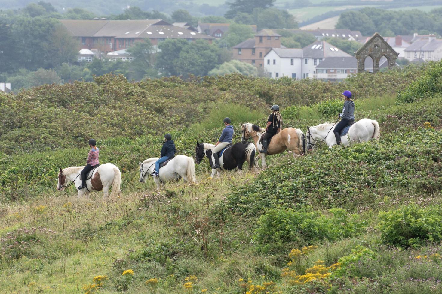 BUDE, CORNWALL, UK - AUGUST 15. Horse riding in Bude in Cornwall on August 15, 2013. Unidentified people. photo