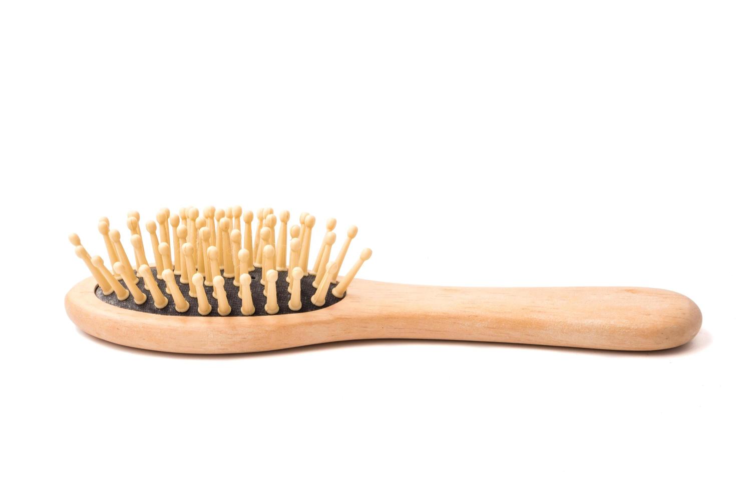 Wooden comb on a white background. photo