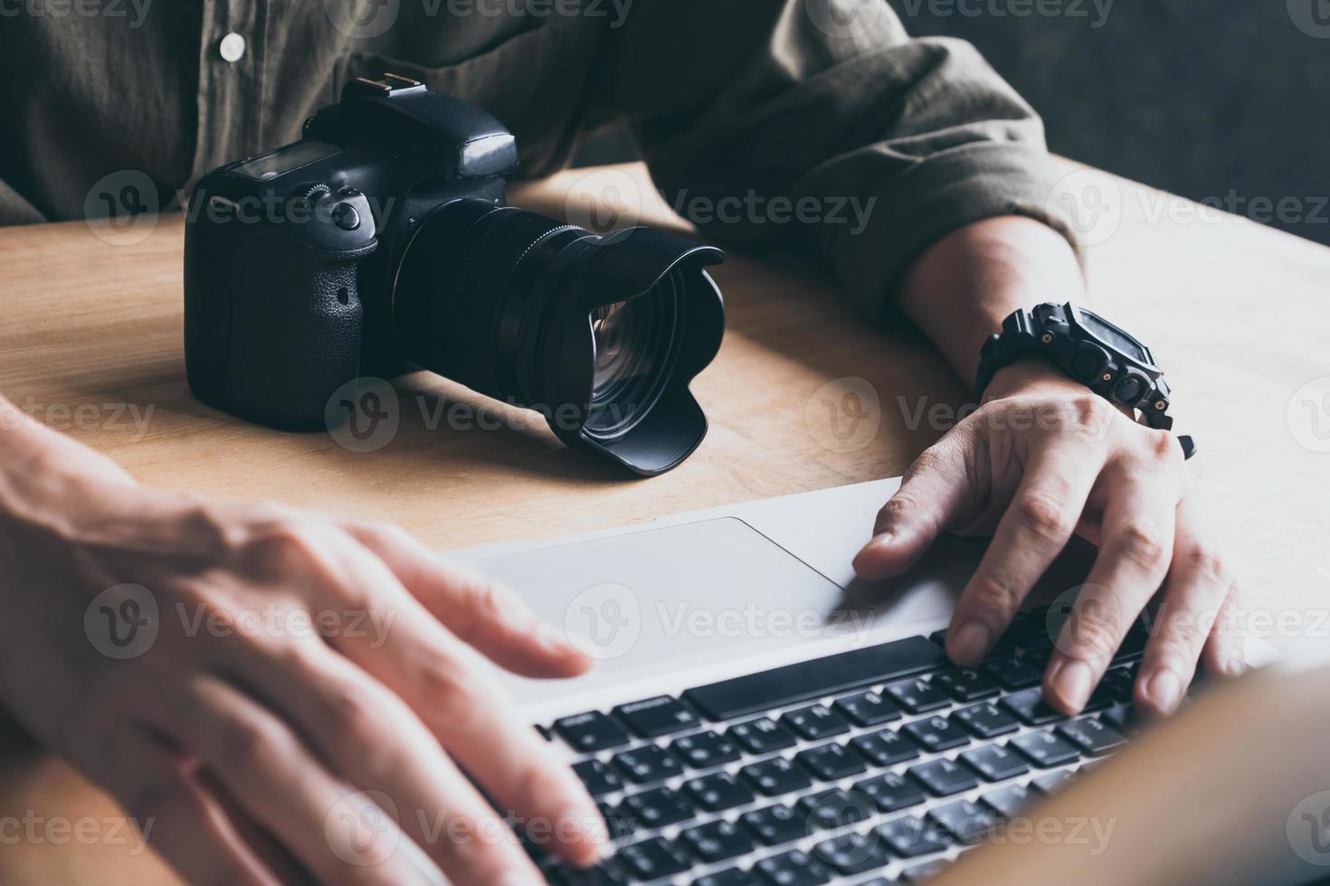 Close up of photographer editing his images on laptop. photo