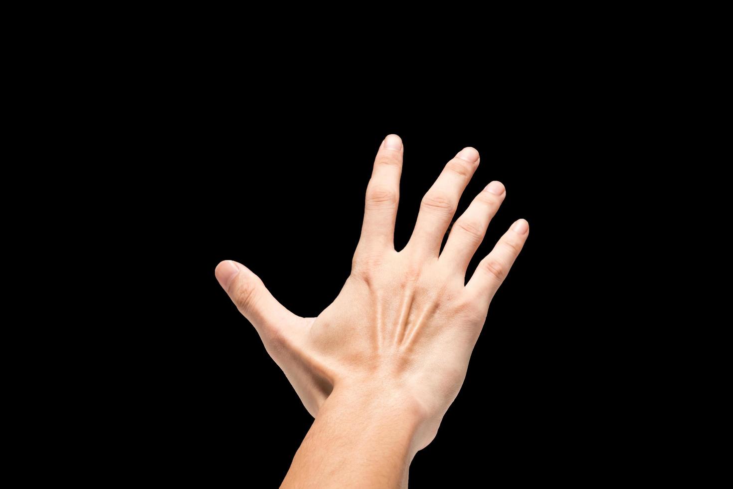 Male hand on a black background. photo