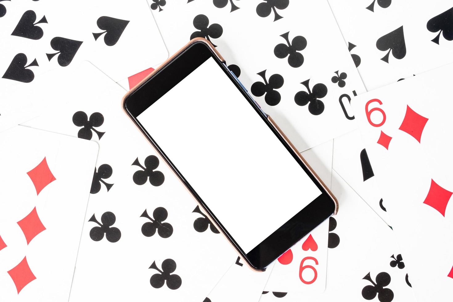 Smart phone with white screen on playing cards background. photo