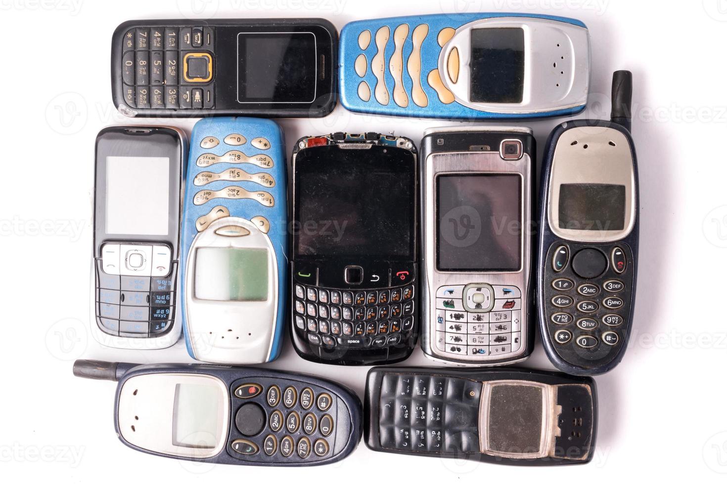 old and obsolete cellphone on a white background. photo