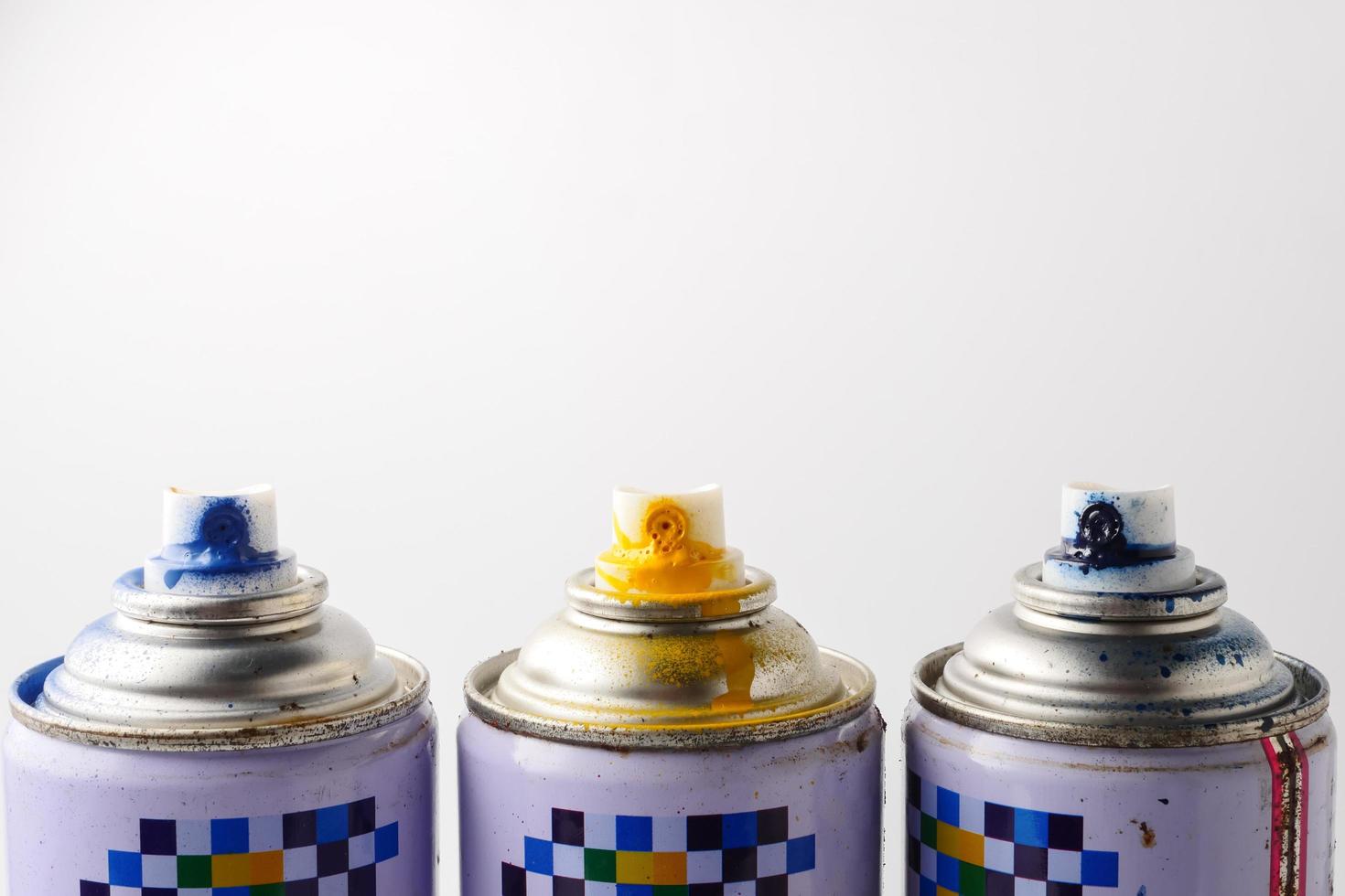Used cans of spray paint on a white background, Close up, Free space for text. photo