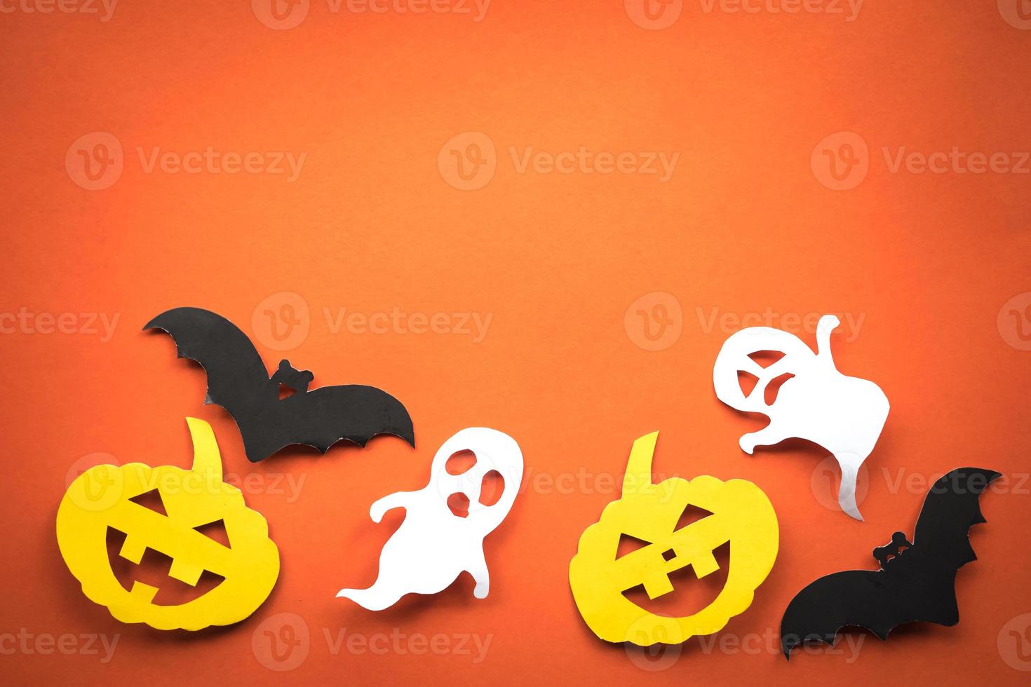 Halloween holiday background with pumpkins, ghosts and bats cut paper on orange background. Free space for text. photo