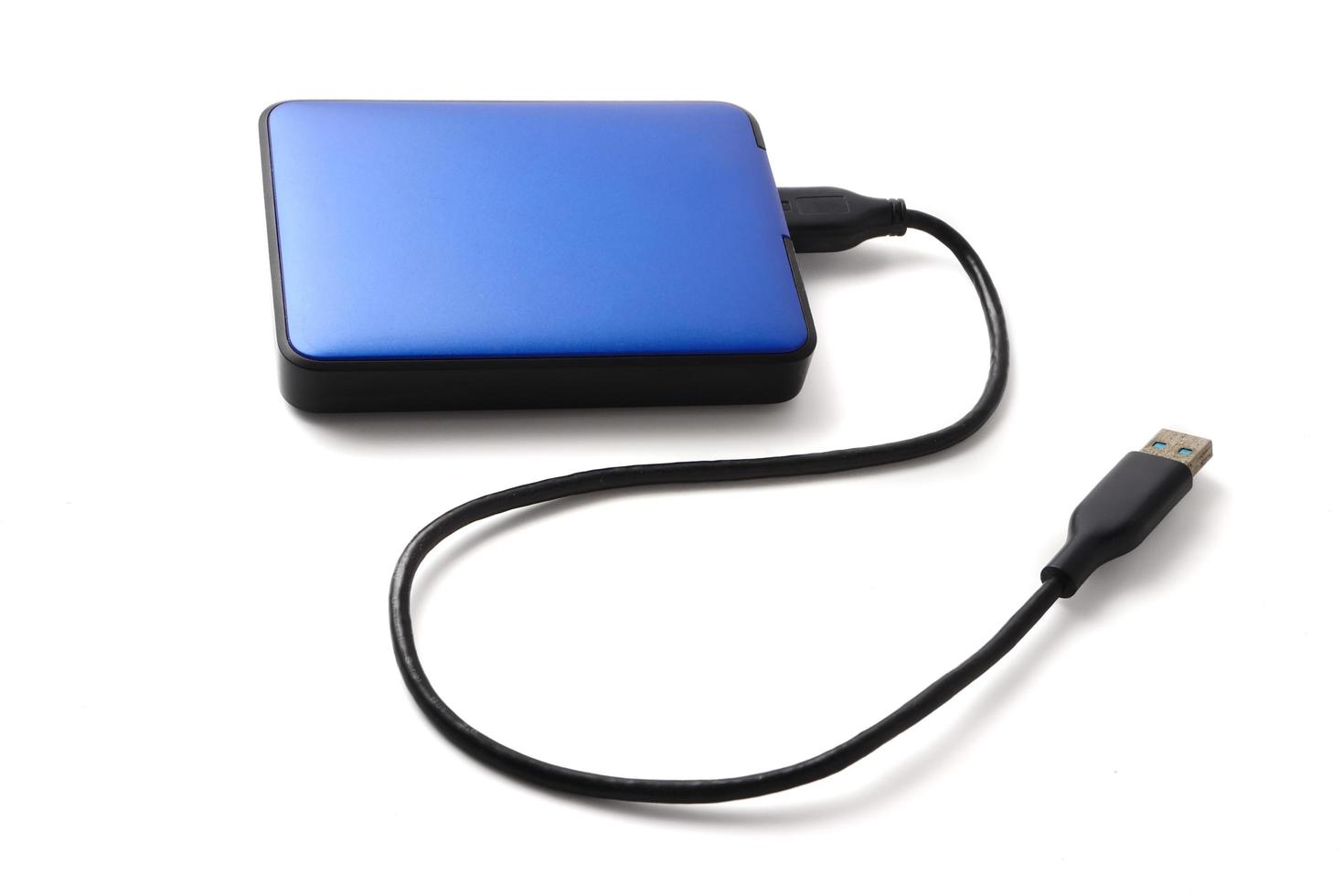 External hard disk drive with cable on a white background. photo