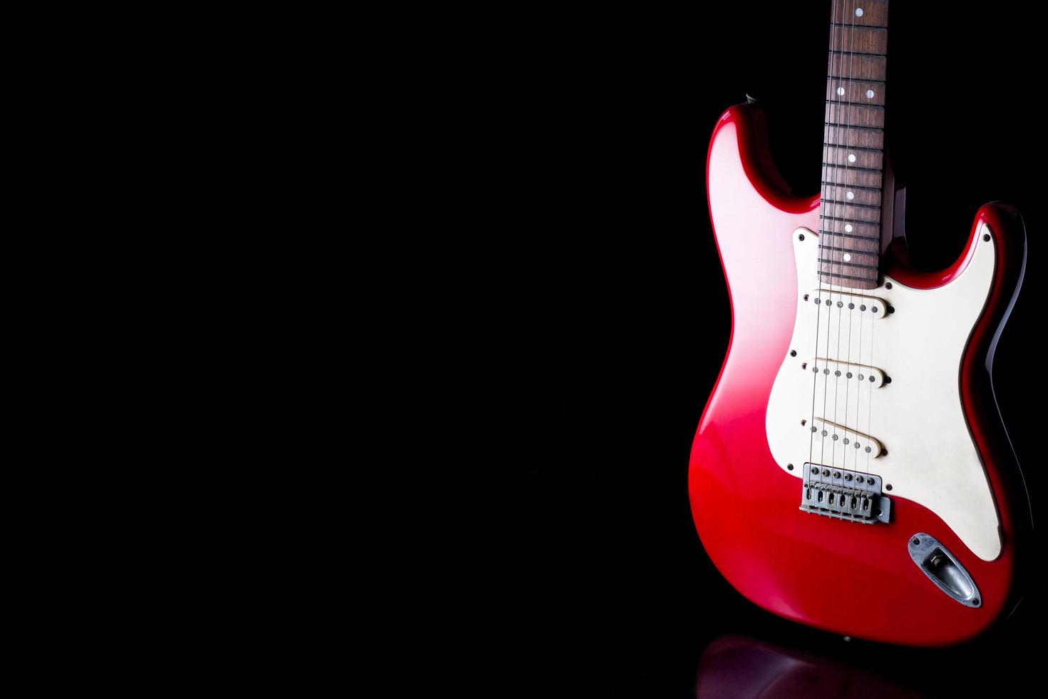 Electric guitar on black background. Free space for text photo