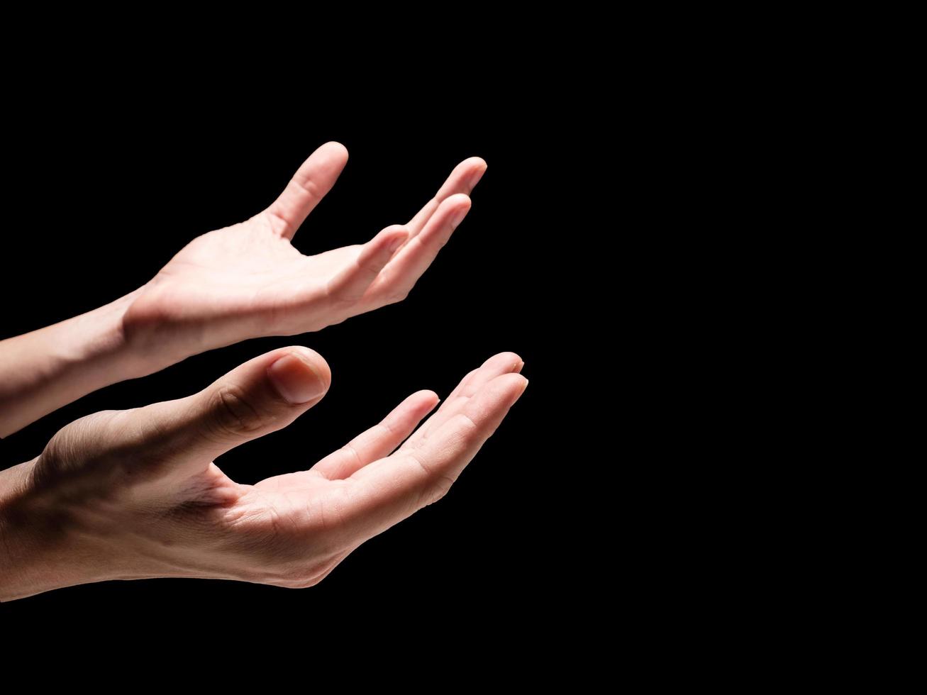 Male hands on a black background. Free space for text photo