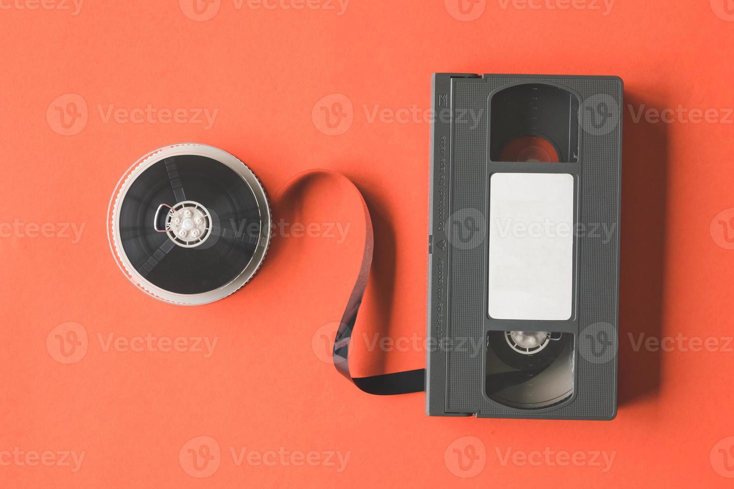 Video cassette tape and reel on orange background. photo