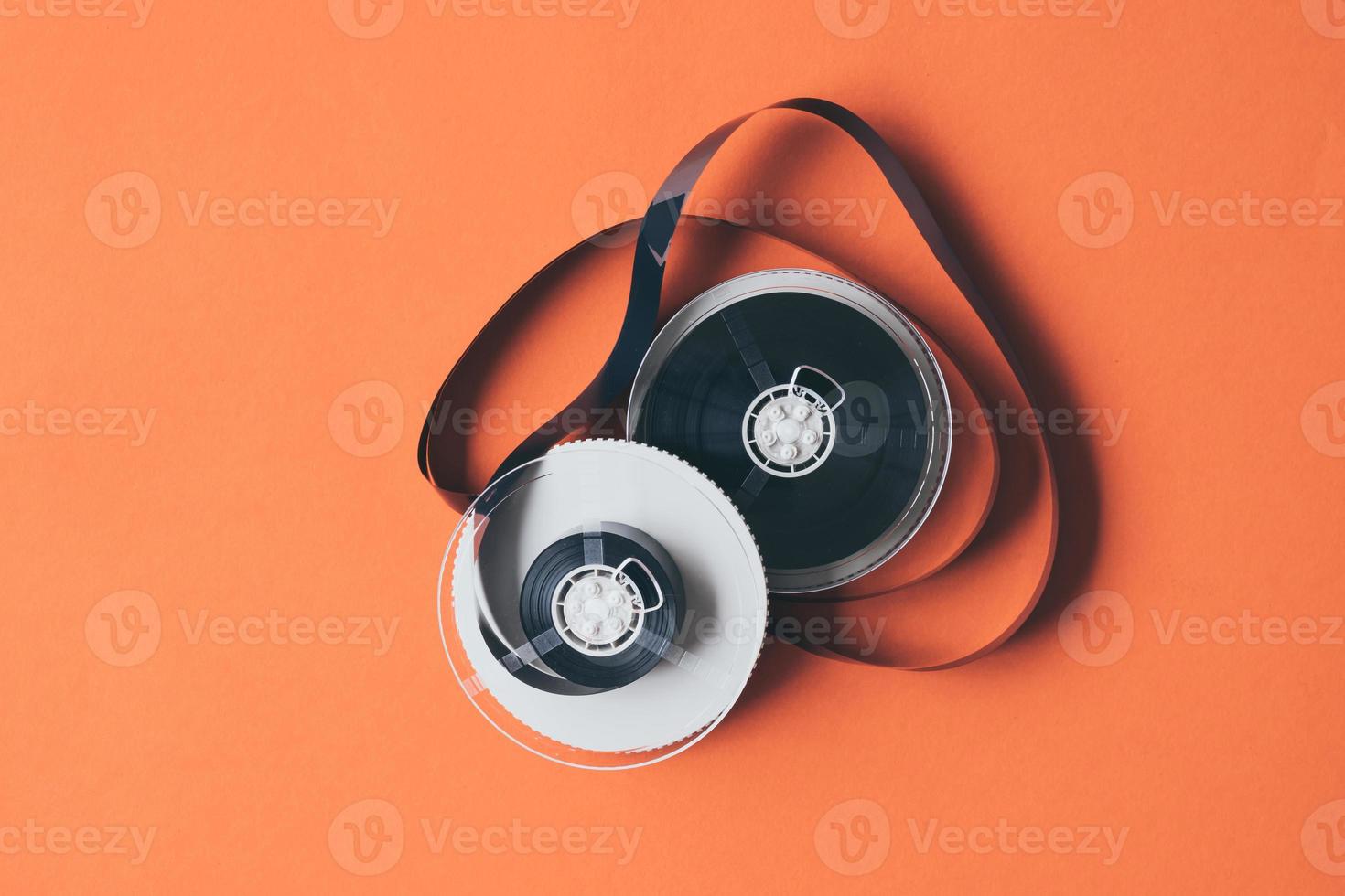 Film for video cassette tape on orange background. photo