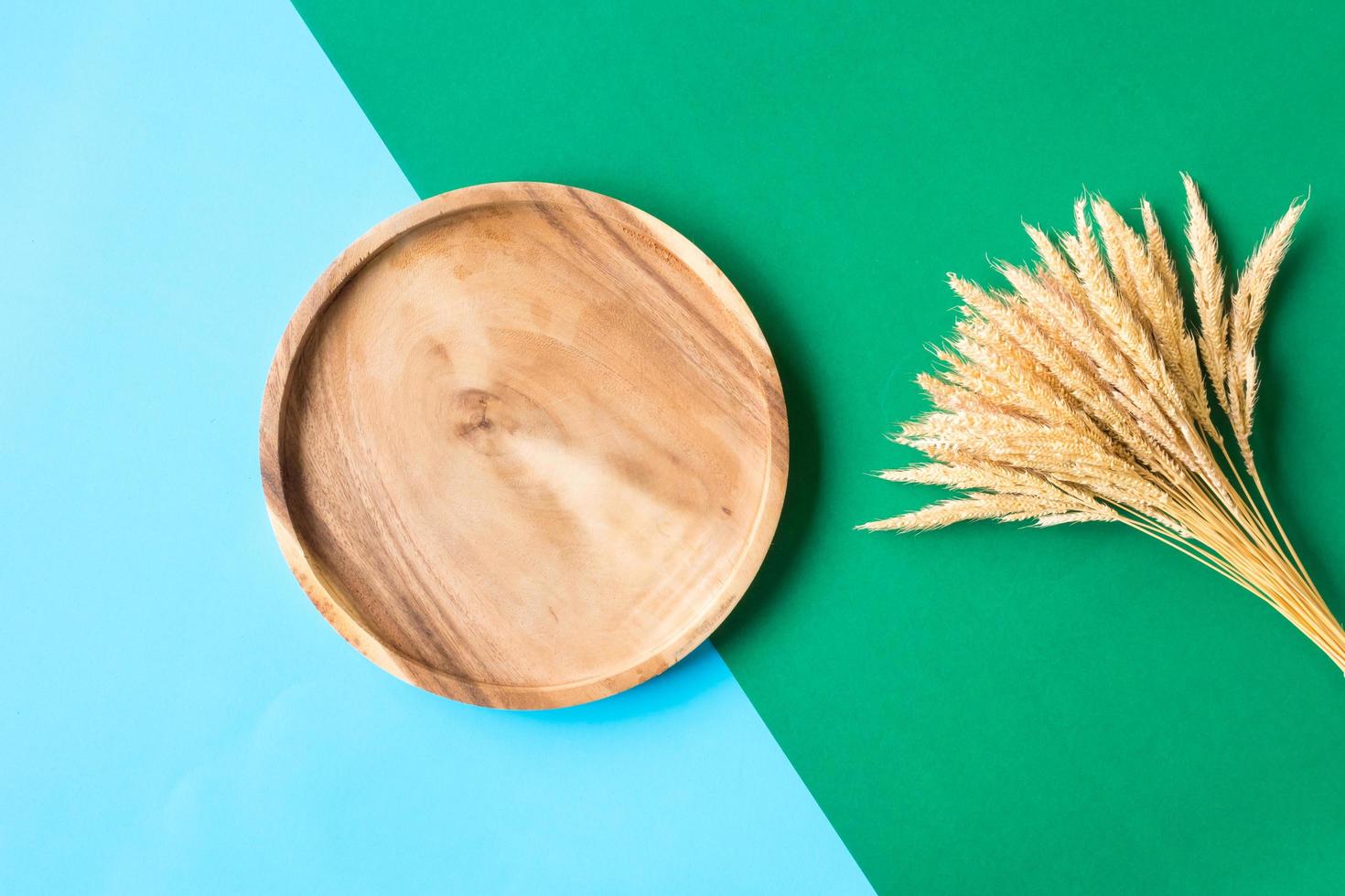 Wooden tray and paddy on colorful background. photo