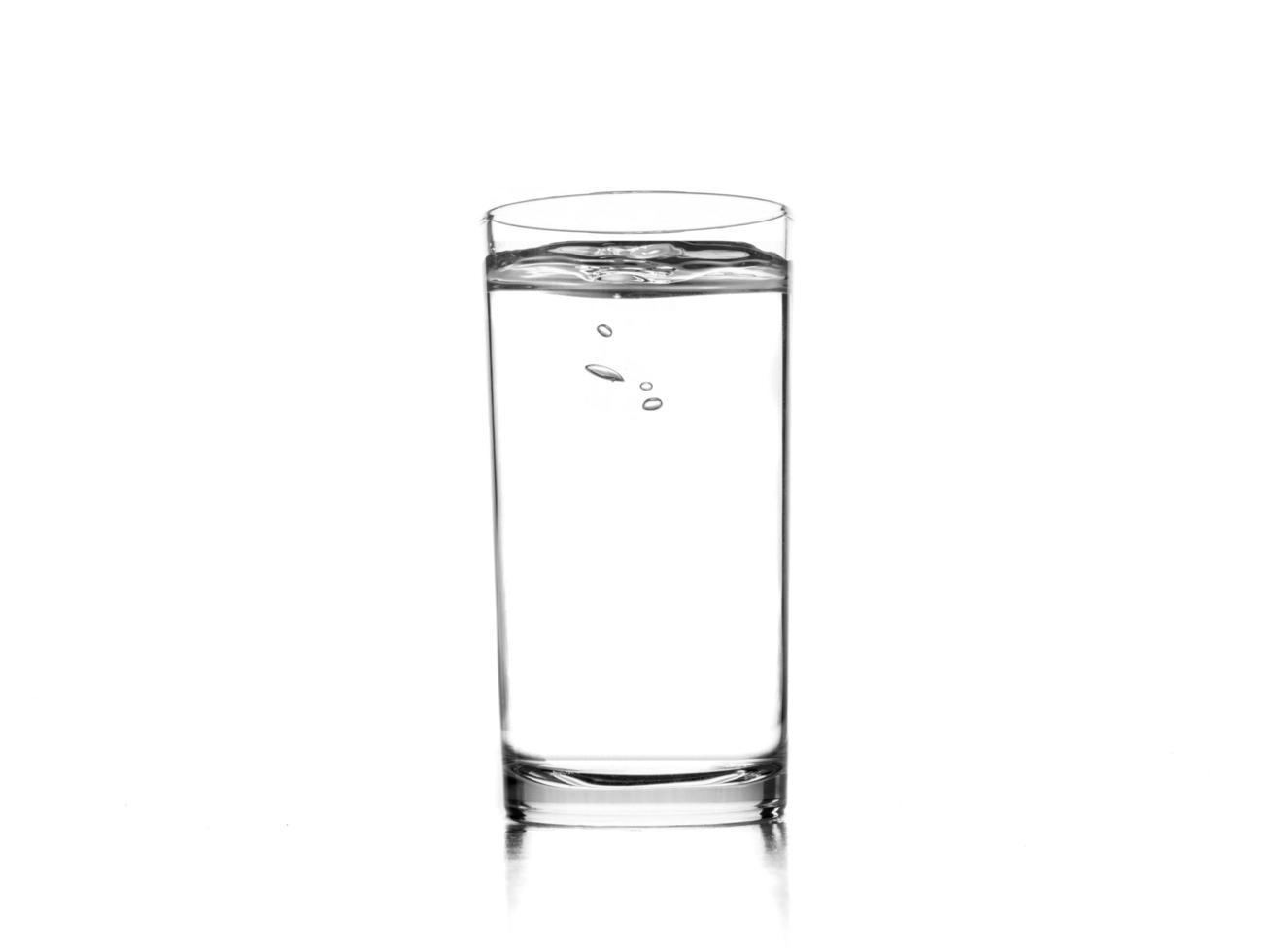 Glass of pure water on white background. photo