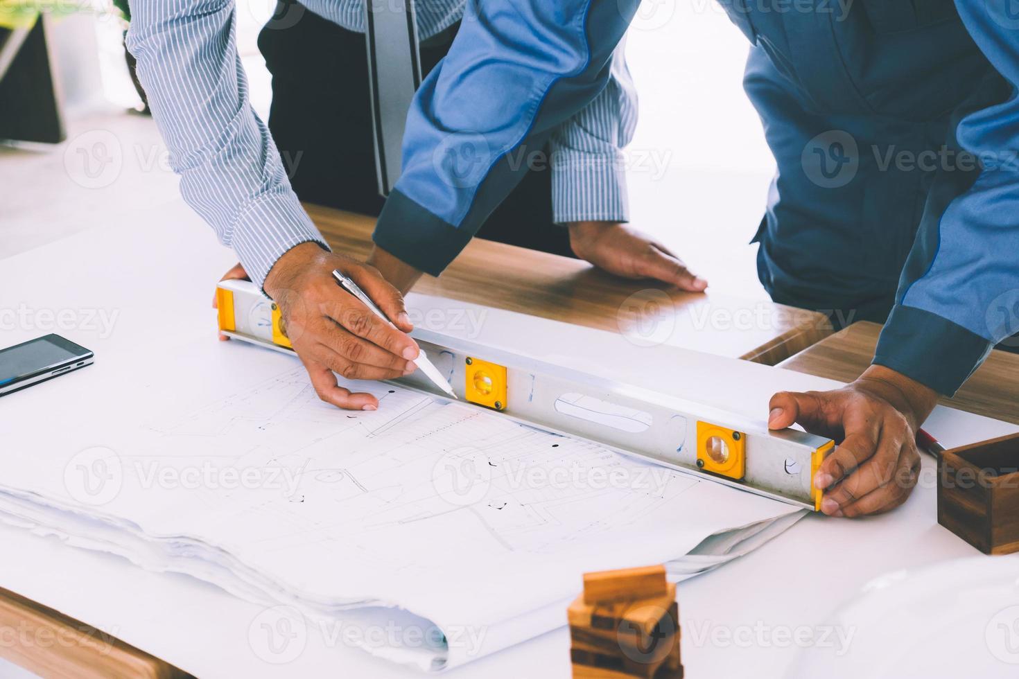 Team of engineers discussing architecture plan sketch at the construction site. photo