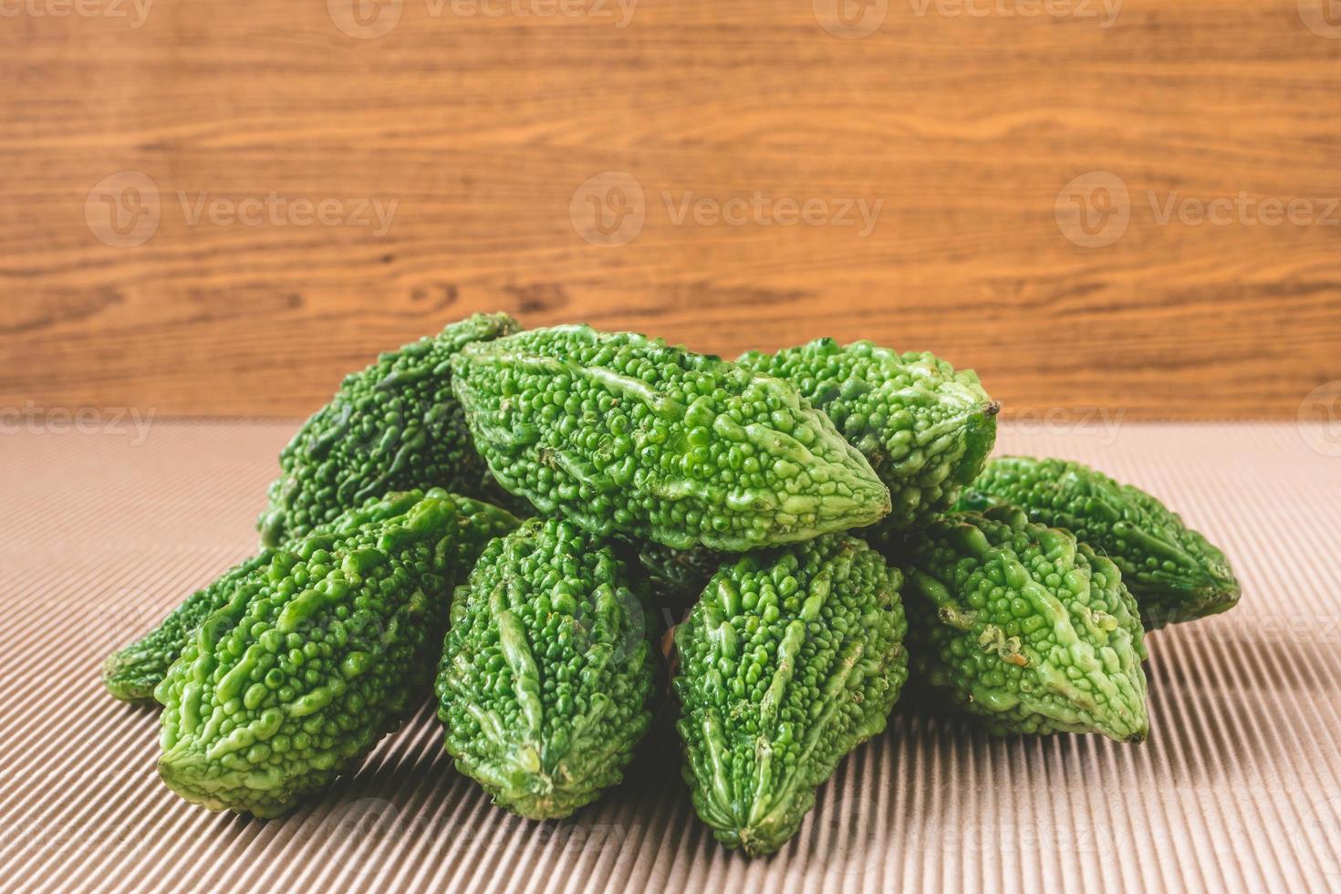 Bitter melon or bitter gourd on wooden background. photo