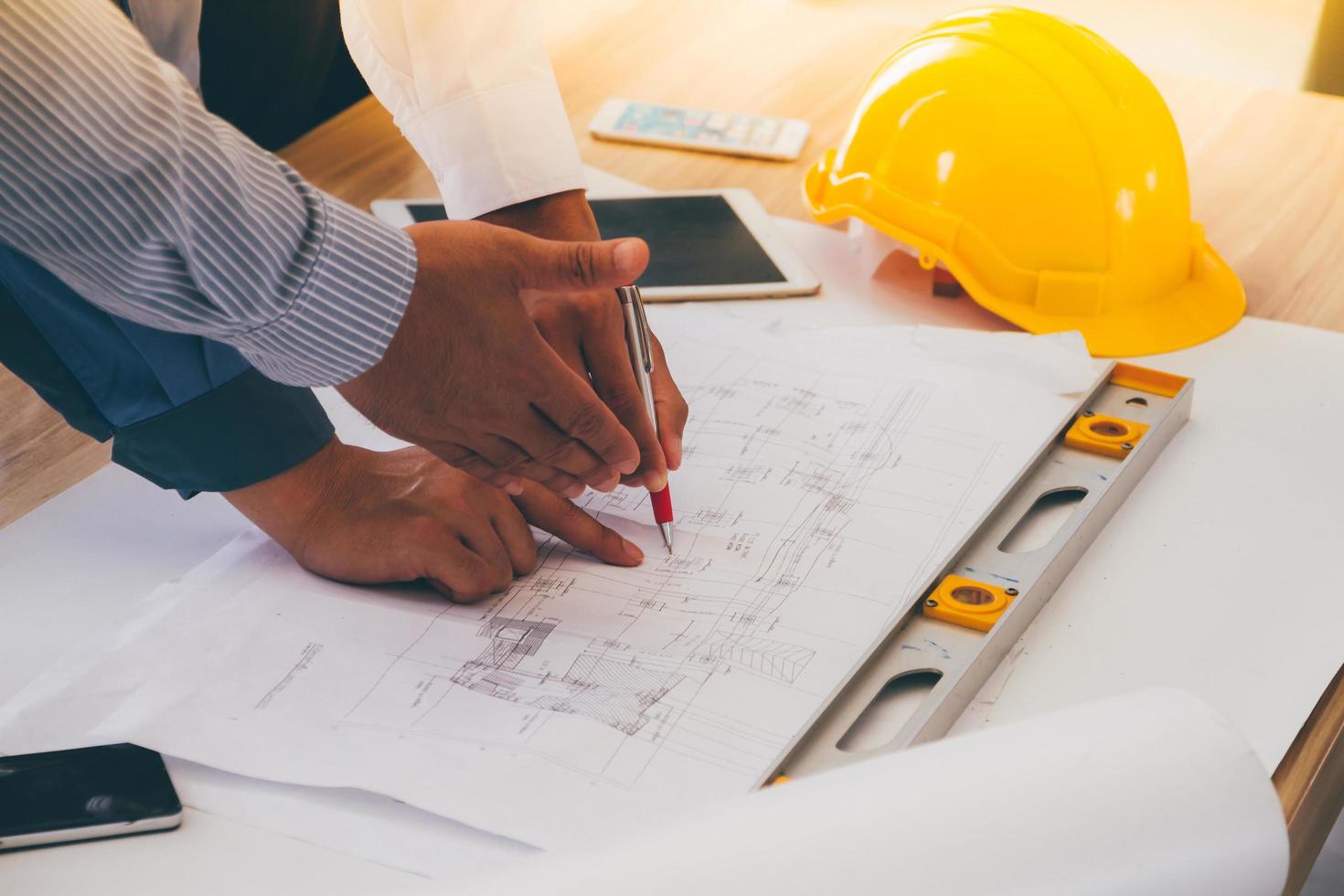 Team of engineers discussing architecture plan sketch at the construction site. photo