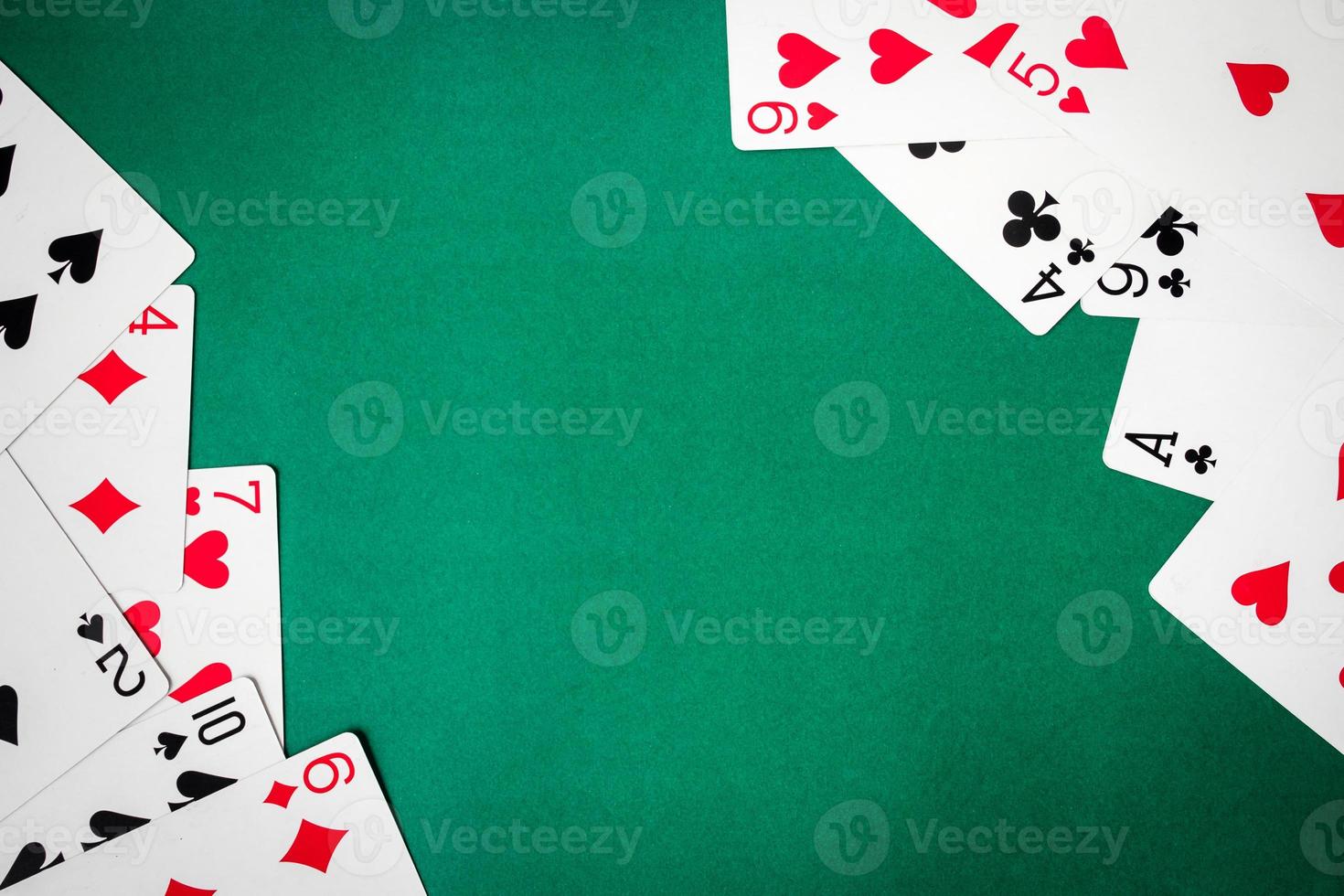 Playing cards on green background. Free space for text photo