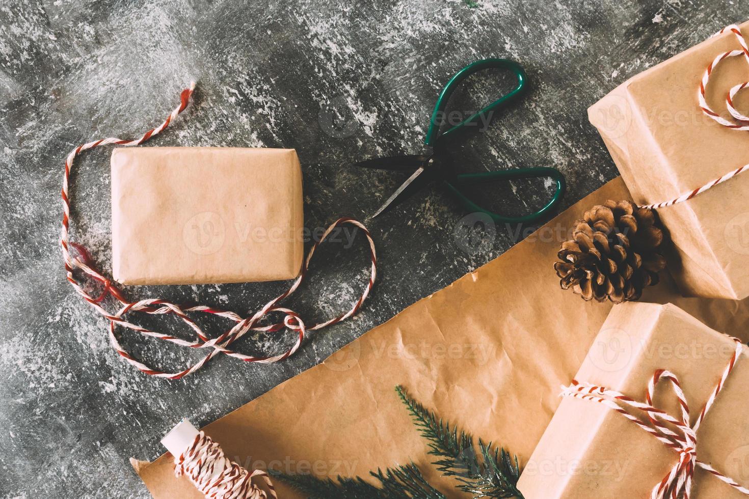 Preparation christmas gifts on gray grunge background. photo