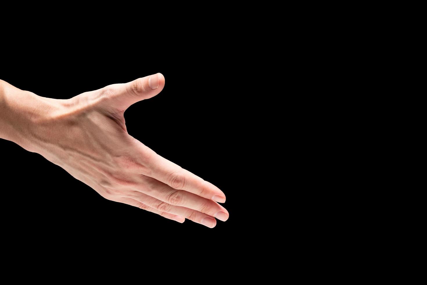 Male hand on a black background. Free space for text photo