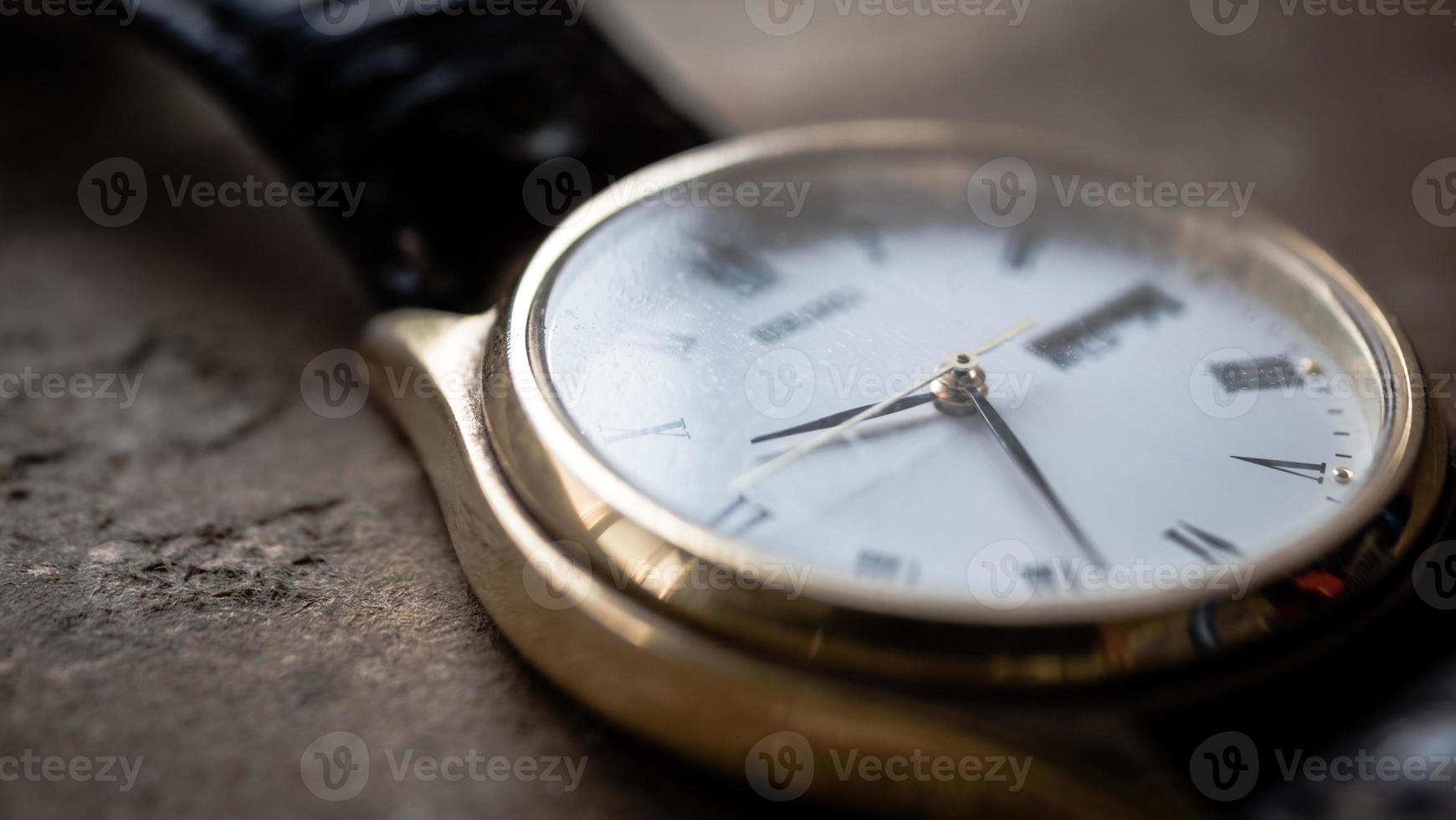 Close up front view of a modern wrist watch on the table. Soft focus photo