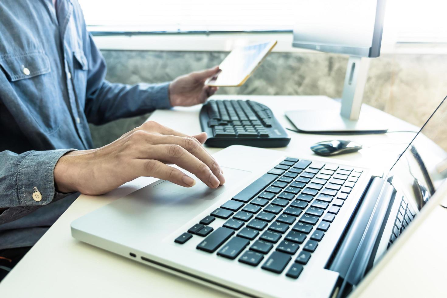 Male hands working on computer and tablet, Software programming web development concept photo