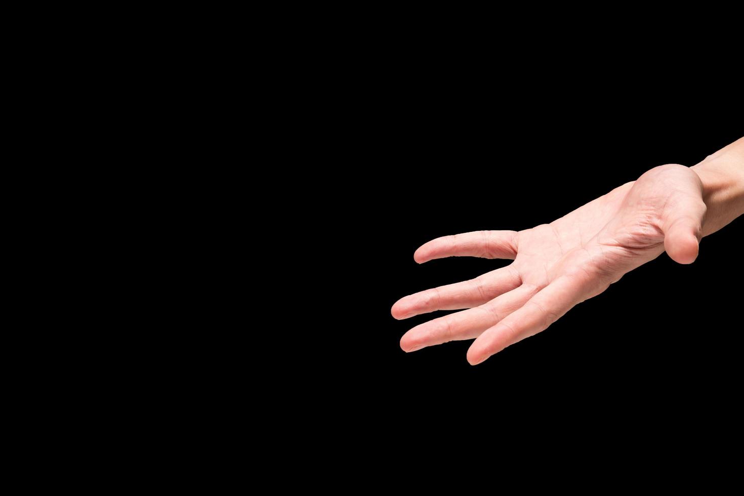 Male hand on a black background. Free space for text photo