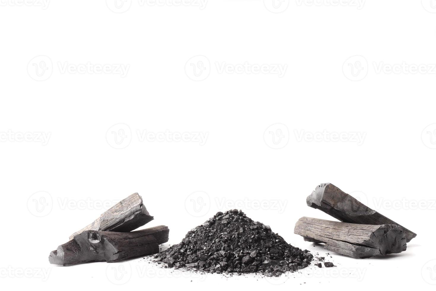 Charcoal and powder activated carbon on white background. Free space for text photo