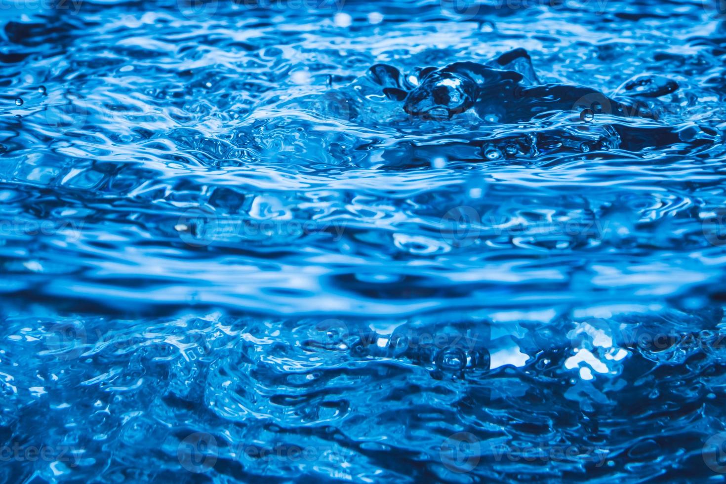 Blue wave and bubbles on water surface background. photo