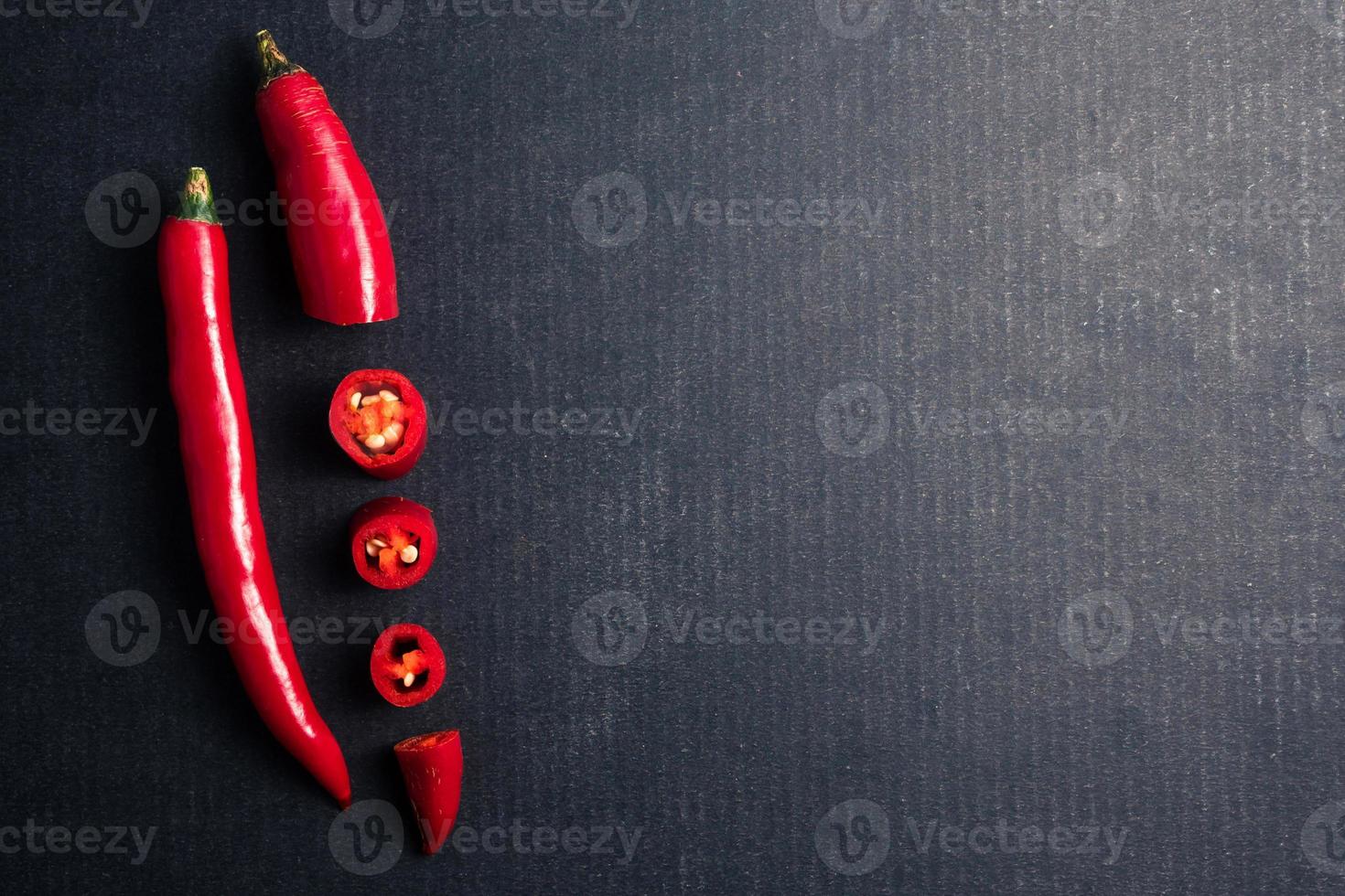 Fresh Red chili papper on black background. Free space for text photo